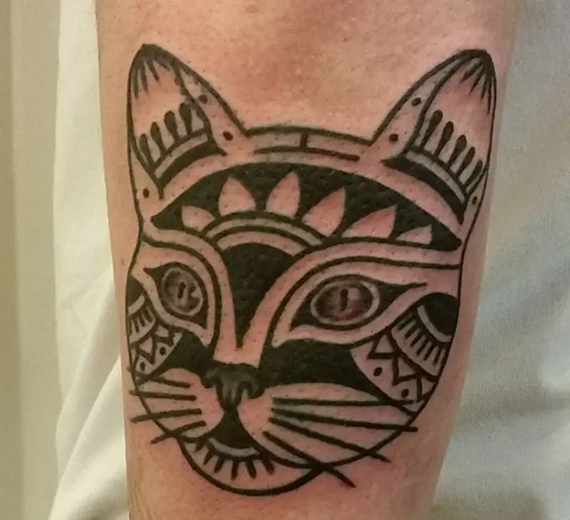 Face of a Tribal Cat Tattoo on the forearm