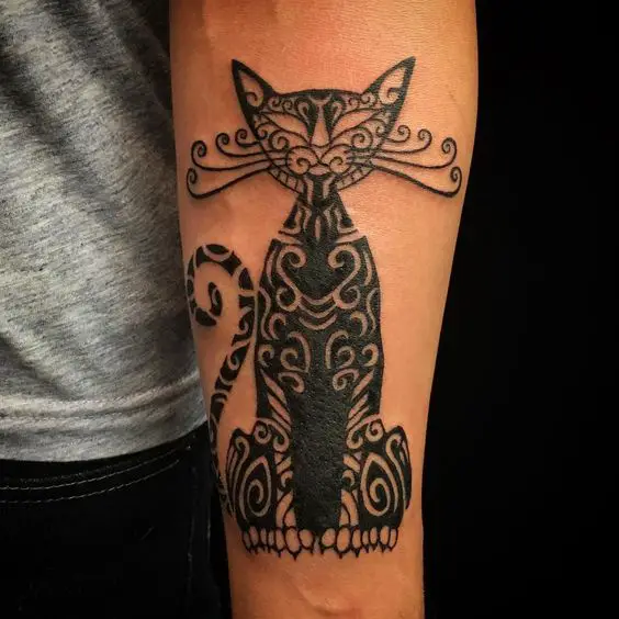 A sitting Tribal Cat Tattoo on the forearm