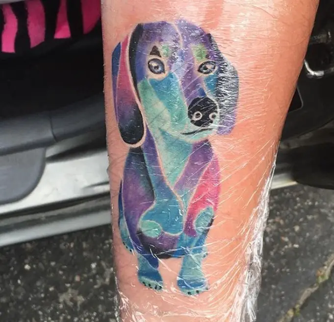 colorful watercolor dachshund dog tattoo on the leg