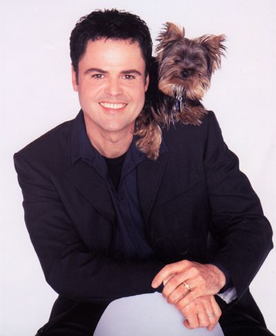 Donnie Osmond with his Yorkshire Terrier over his shoulder