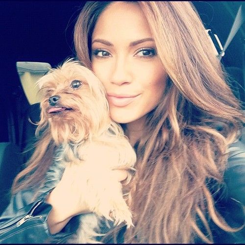 Jennifer Lopez taking a selfie inside the car while holding her Yorkshire Terrier