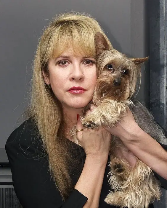 Stevie Nicks while holding her Yorkshire Terrier