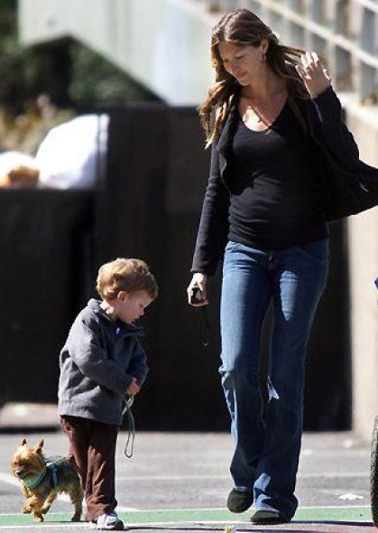 GISELE BUNDCHEN with his kid walking a Yorkshire Terrier in the street