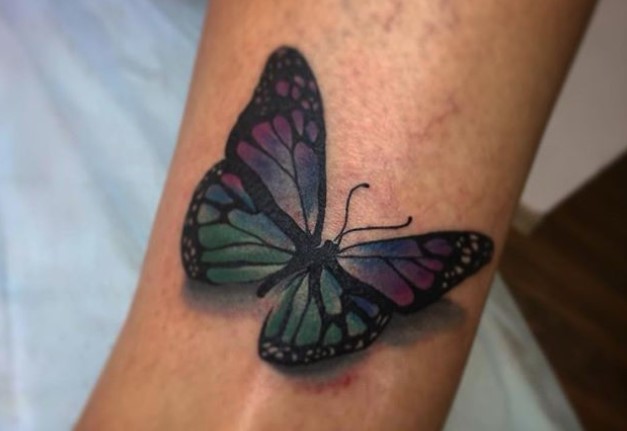 purple, blue, and green 3D tattoo