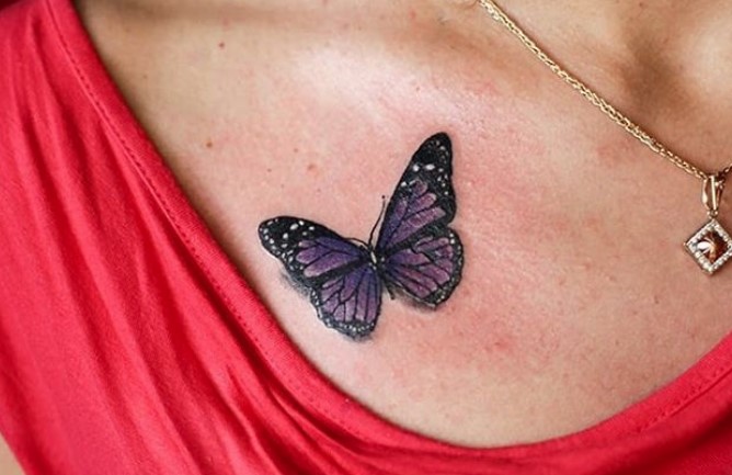 Purple butterfly tattoo on chest