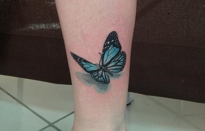 Blue butterfly tattoo on wrist