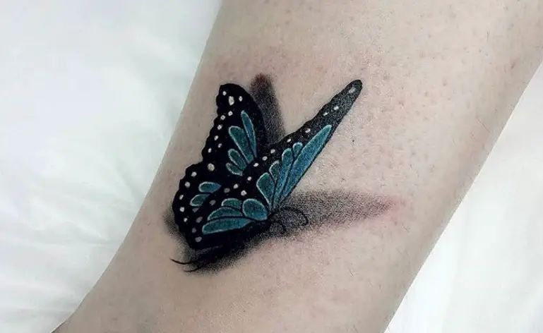 Blue 3D butterfly tattoo on ankle