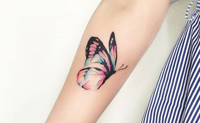 watercolor butterfly tattoo on forearm