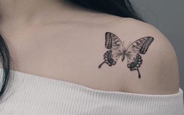 Black Butterfly tattoo on shoulder