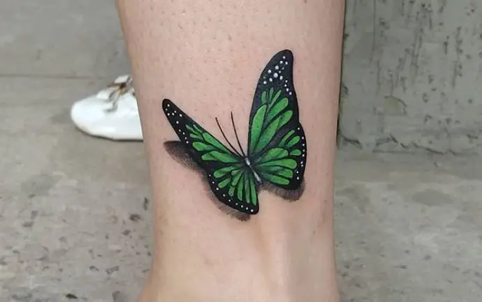 Green butterfly tattoo on ankle