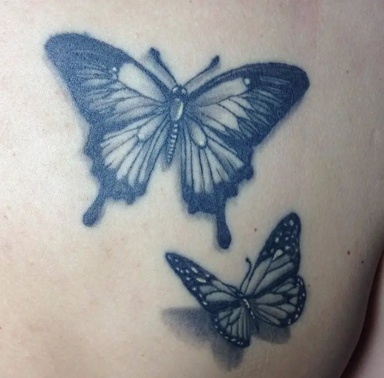 Two black butterflies tattoo