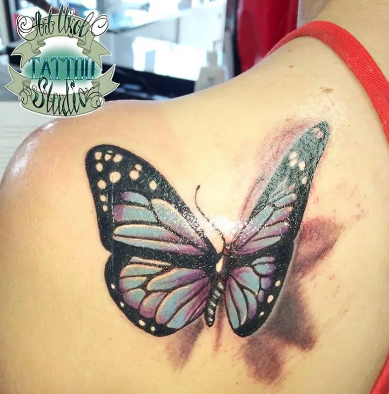 3D blue butterfly tattoo on shoulder
