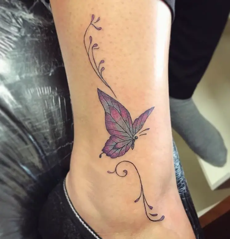 Purple and pink butterfly tattoo on ankle