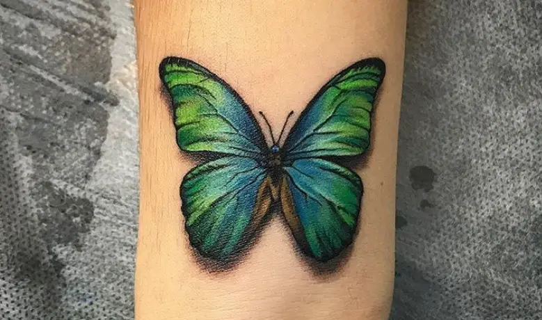 Vibrant blue and green butterfly tattoo