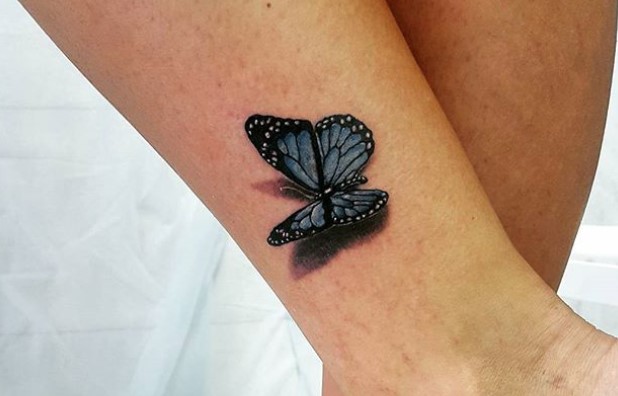 Blue butterfly tattoo on ankle