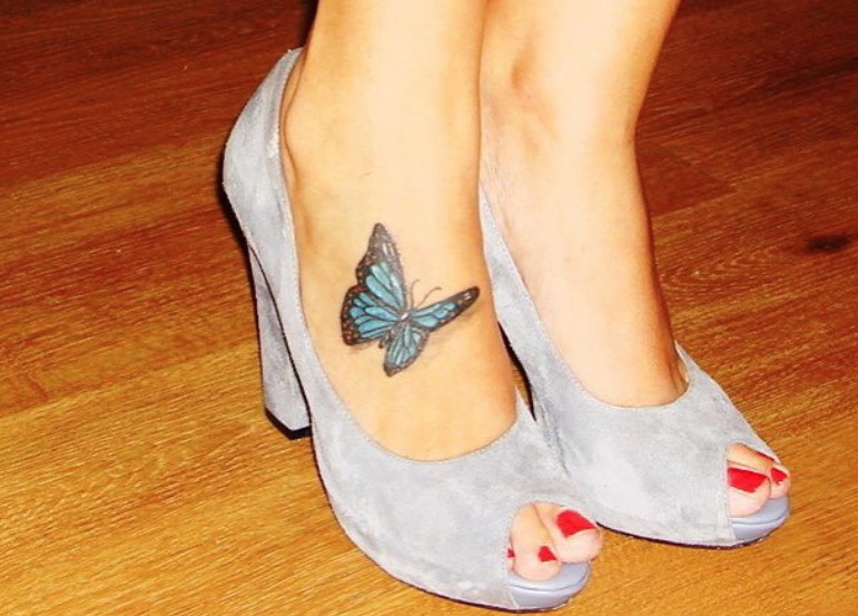 blue 3D butterfly tattoo on feet