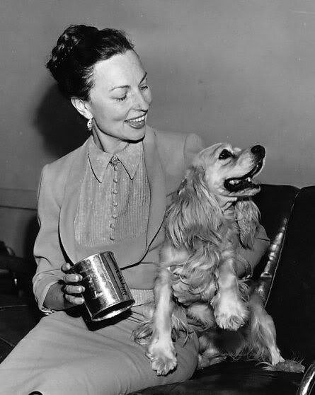 Agnes Moorehead siting on the couch with her Cocker Spaniel