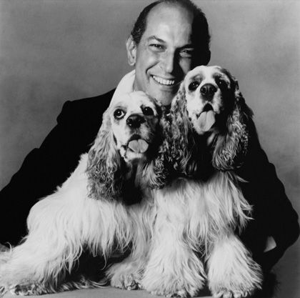 black and white photo of a Oscar de la Renta with his two Cocker Spaniels