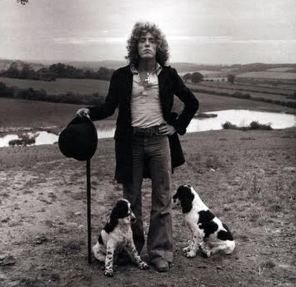 Roger Daltrey by the lake with his two Cocker Spaniel sitting on the ground