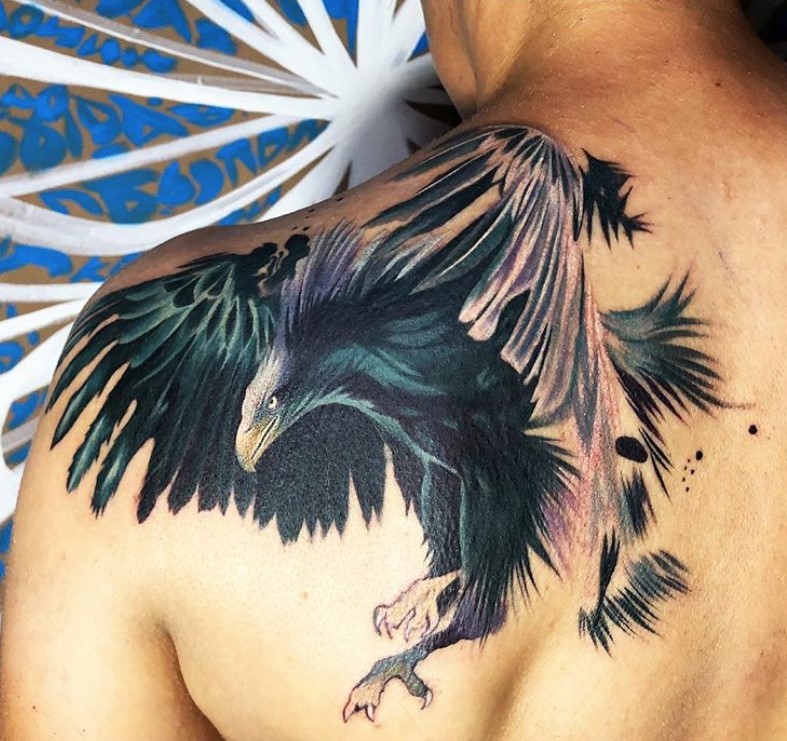 realistic black eagle tattoo on shoulder.