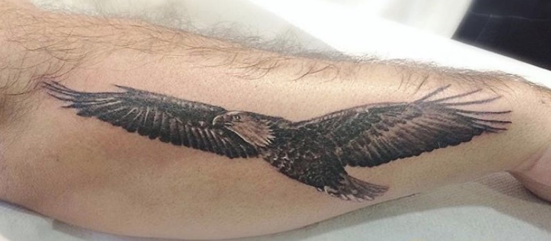 black and gray Soaring eagle tattoo on forearm.