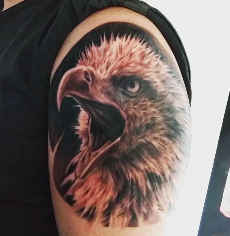 red and black Eagle with its beak open Tattoo on the shoulder
