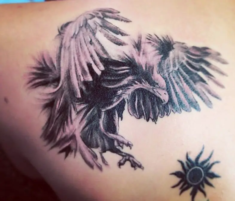 black and gray Eagle, flying towards the sun symbol tattoo on the back