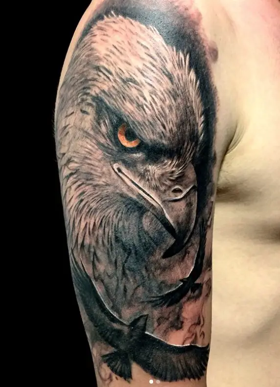 sideview face of a 3D Eagle and surrounded with small flying eagle tattoo on the shoulder