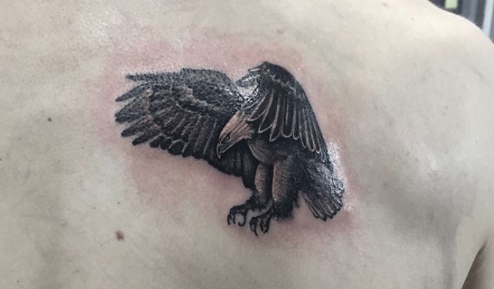 flying black Eagle Tattoo on the back