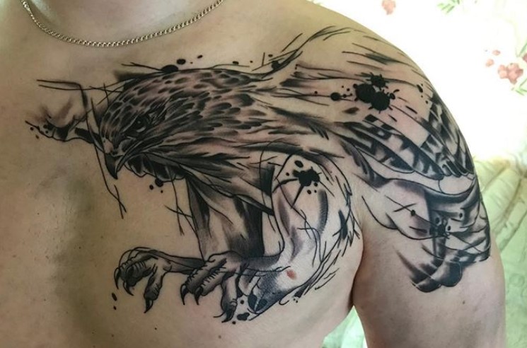 artistic black and gray flying eagle tattoo on the chest