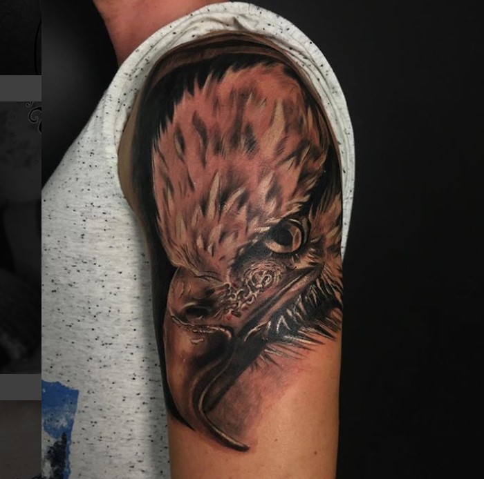 realistic black and gray sideview face of an Eagle Tattoo on the shoulder
