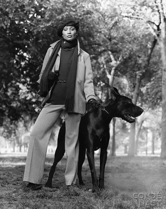 Beverly Johnson standing in the forest with a Great Dane next to her