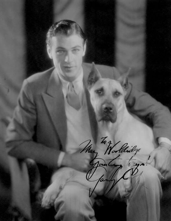 Gary Cooper sitting on the chair with his Great Dane