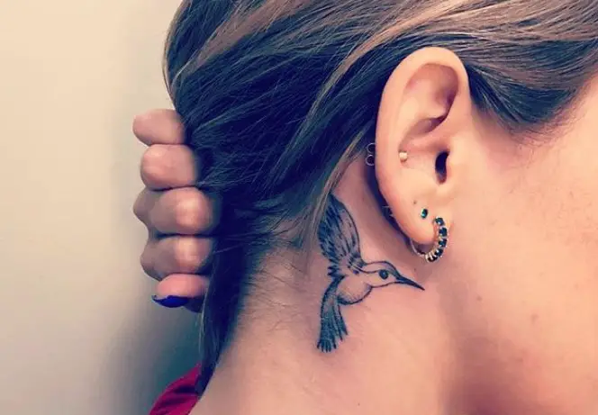 small hummingbird tattoo behind the ears