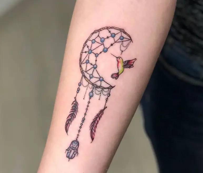 small colorful hummingbird with dreamcatcher tattoo on forearms
