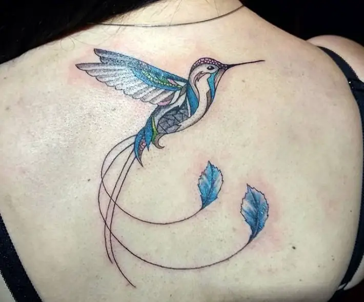 colorful (but mostly blue colored) hummingbird tattoo on back