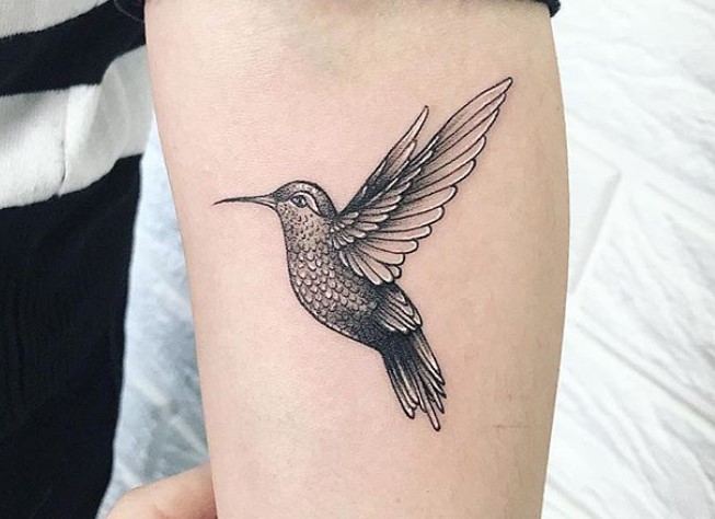 simple hummingbird tattoo on forearm