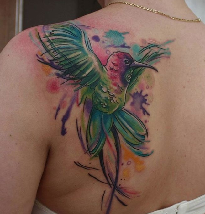large colorful hummingbird watercolor tattoo on the back