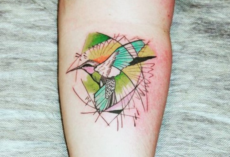 colorful geometric hummingbird tattoo on forearm