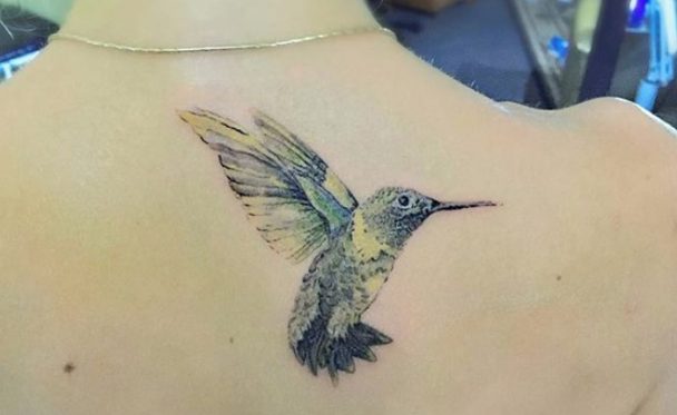 melodic hummingbird tattoo on the back