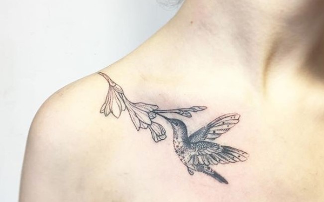 hummingbird pollinating a flower tattoo on shoulder going to chest