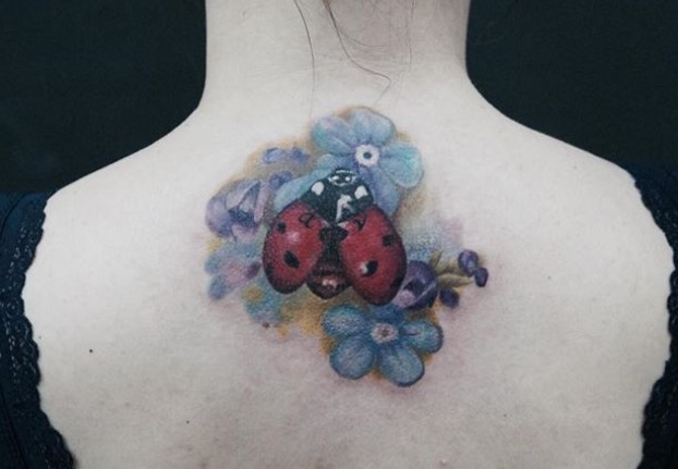 3D Ladybug on purple flowers Tattoo on the back