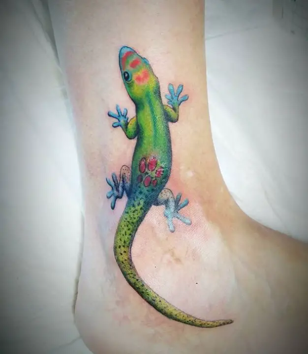 green Lizard with blue feet and touches of blue and yellow colors Tattoo on the ankle