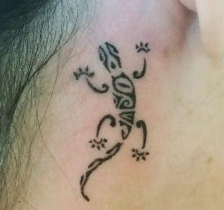 small tribal Lizard Tattoo behind the ear