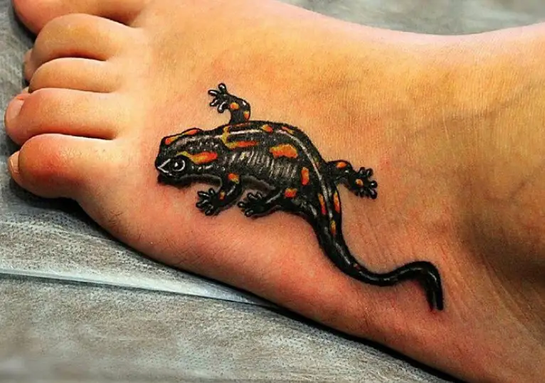Lizard with black and orange color pattern Tattoo on foot