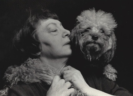 Dorothy Parker with her poodle over her shoulder