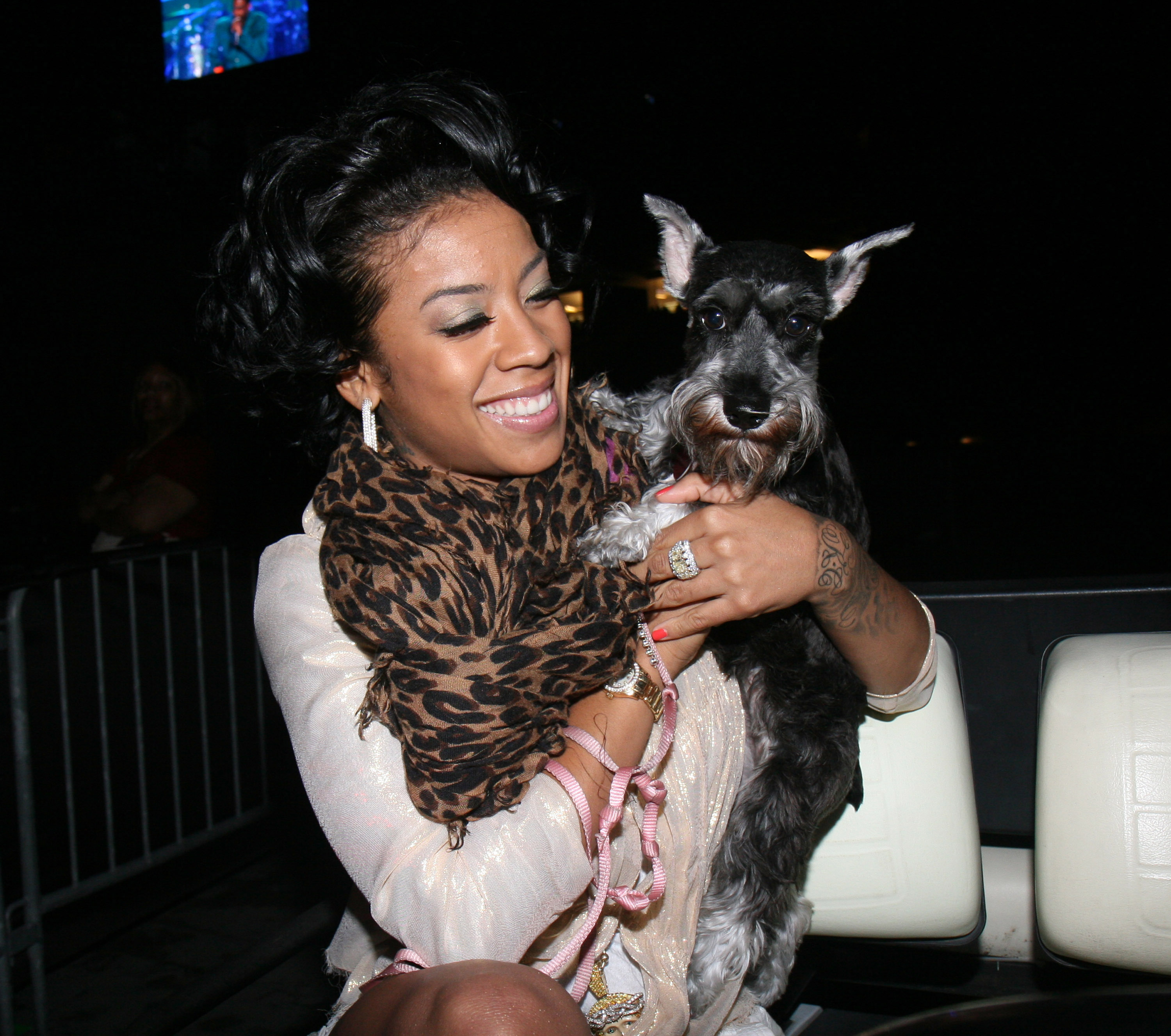 Keyshia Coles carrying her Schnauzer puppy