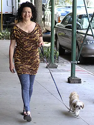 Susie Essman walking in the street with her Shih Tzu