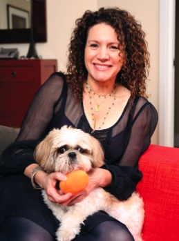Susie Essman sitting on the couch with her Shih Tzu on her lap