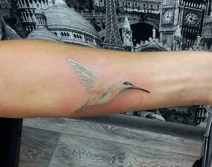 minimalist silver Small Hummingbird Tattoo on the forearm